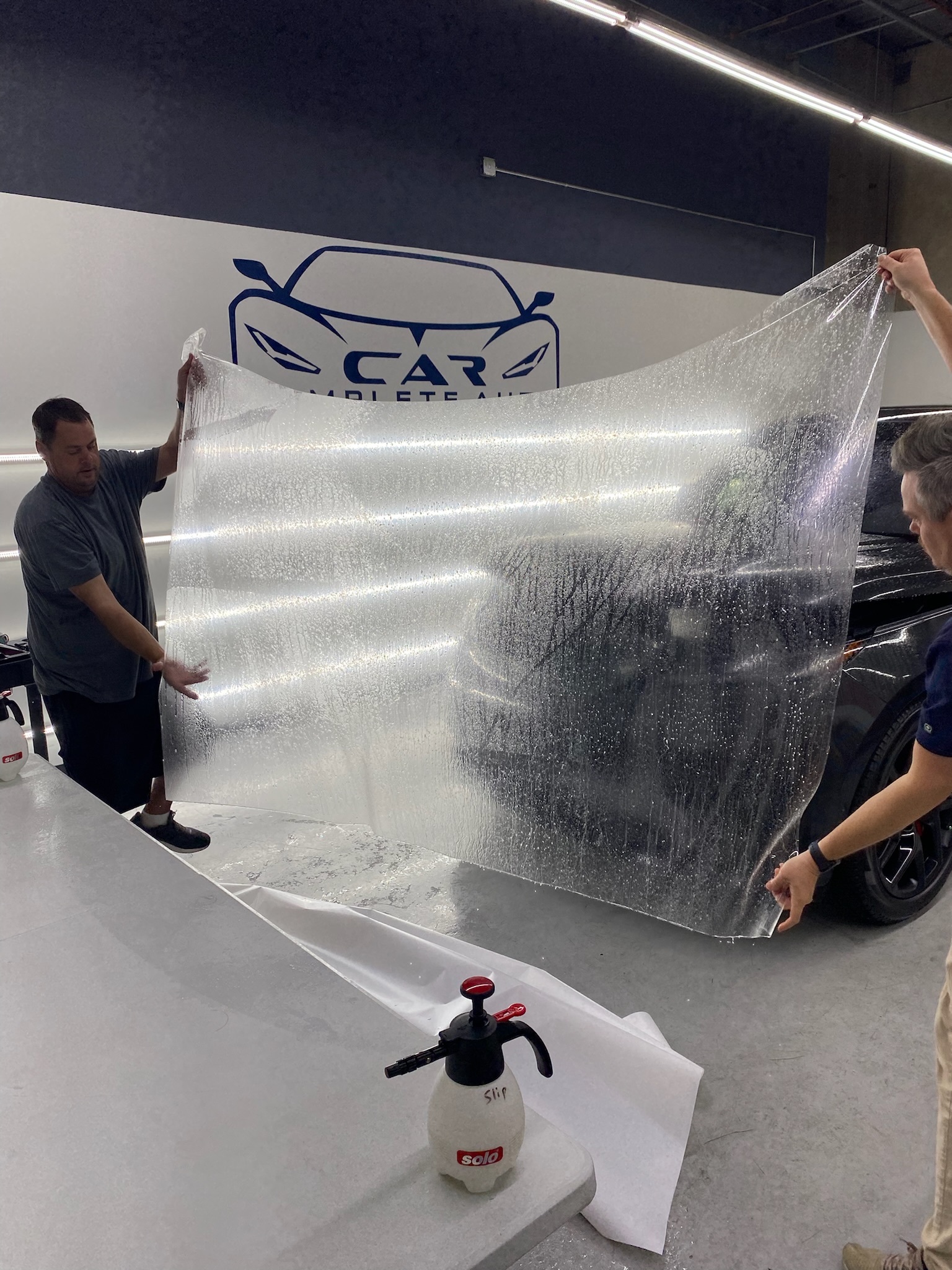Car and Air technicians preparing paint protection film in Marietta, Georgia